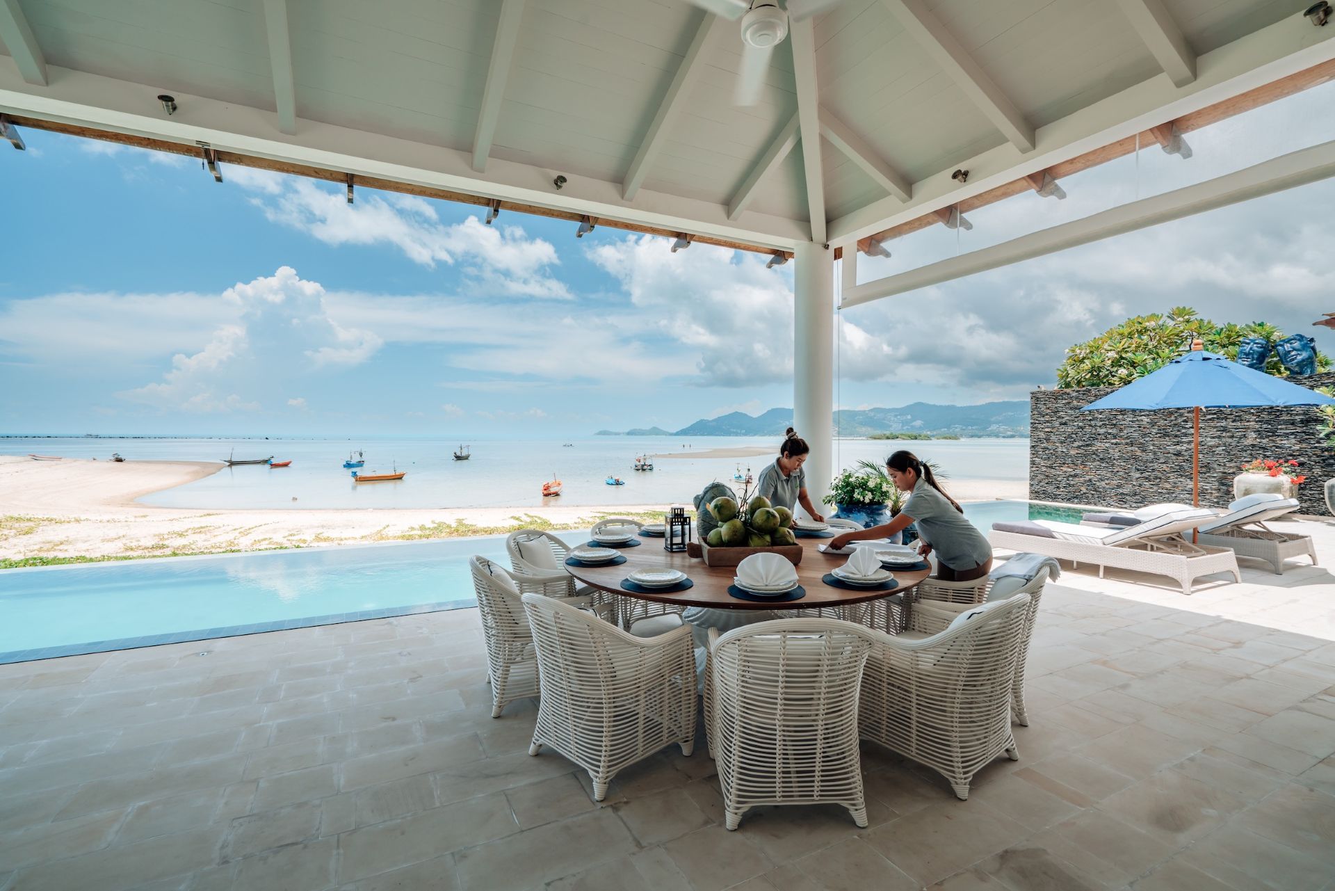 Villa staff preparing the table for the guest's breakfast